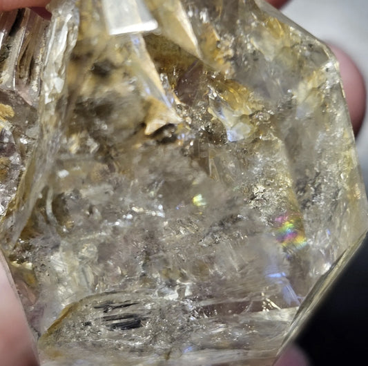 Close-up view of a rare 27-gram Herkimer Diamond quartz crystal showing its brilliant clarity, sharp termination points, and light-catching natural inclusions.