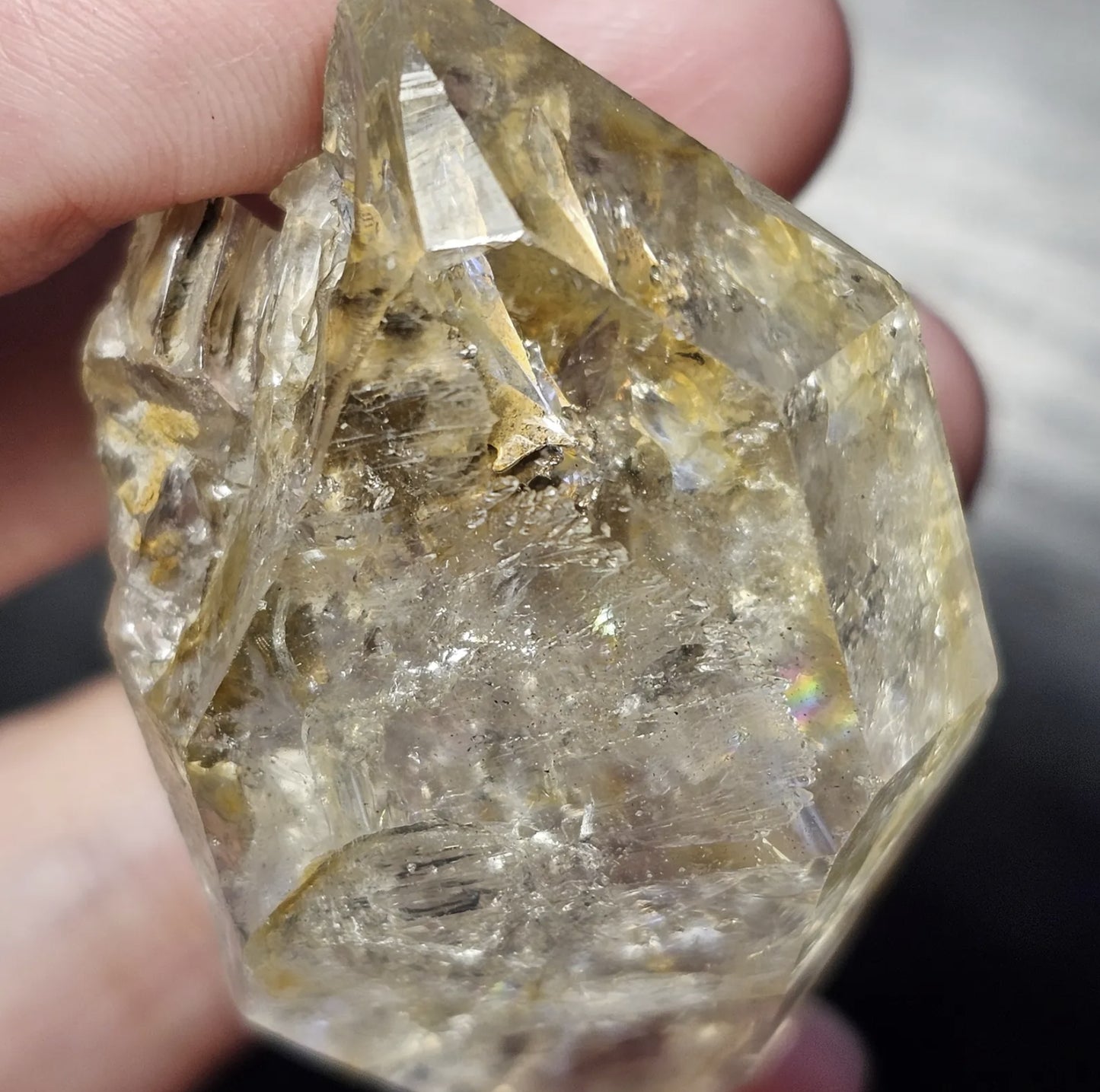 Close-up view of a rare 27-gram Herkimer Diamond quartz crystal showing its brilliant clarity, sharp termination points, and light-catching natural inclusions.