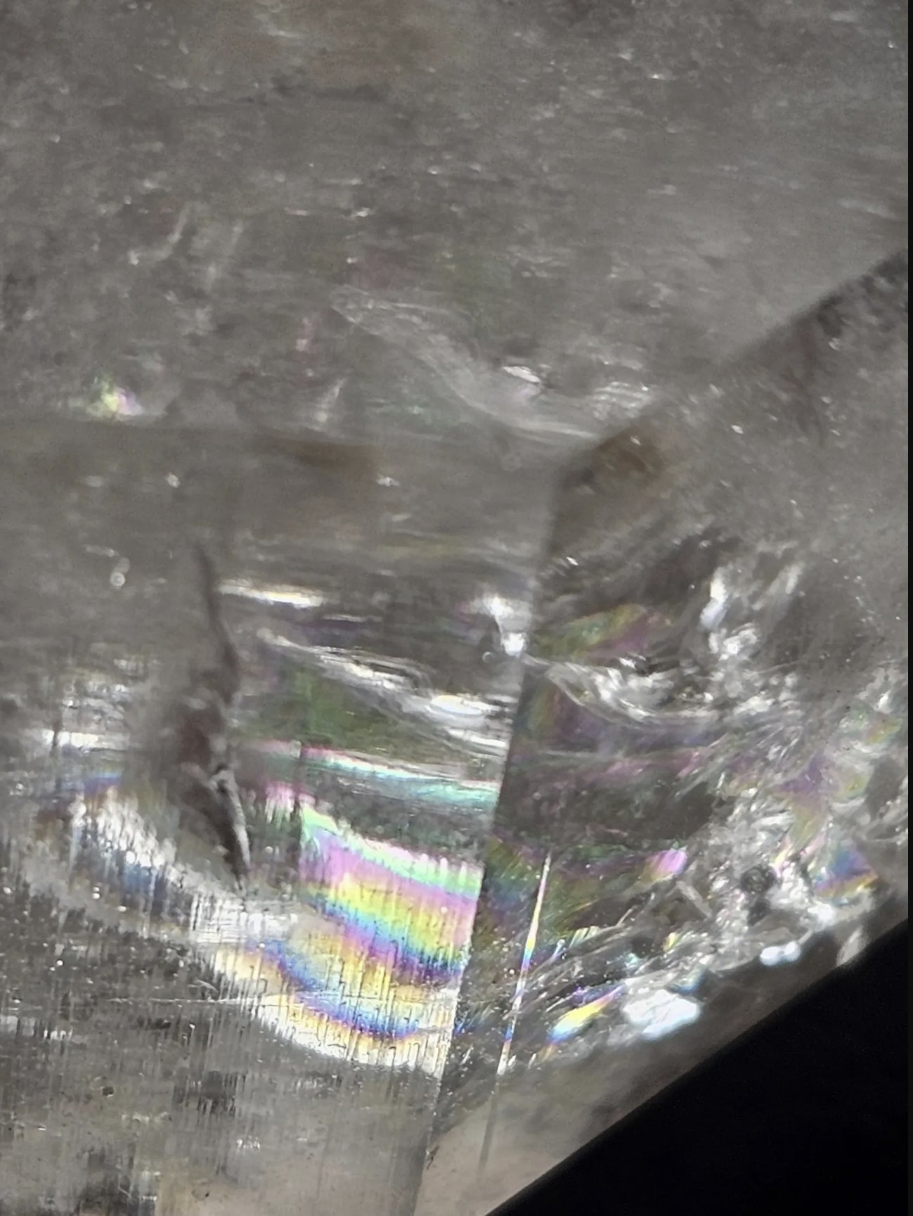 Rainbow fracture inside Lemurian seed quartz point, macro view