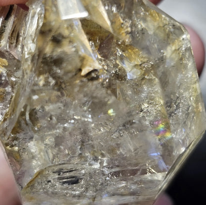 Close-up view of a rare 27-gram Herkimer Diamond quartz crystal showing its brilliant clarity, sharp termination points, and light-catching natural inclusions.