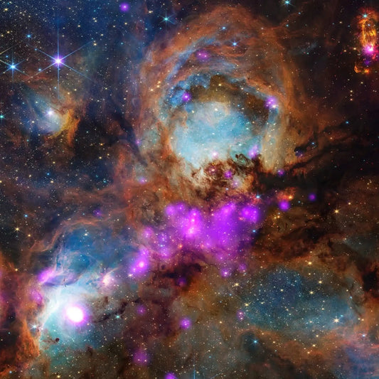 Cat's Paw Nebula (NGC 6334) — purple and orange cosmic gas and dust. Image: NASA/CXC/JWST.