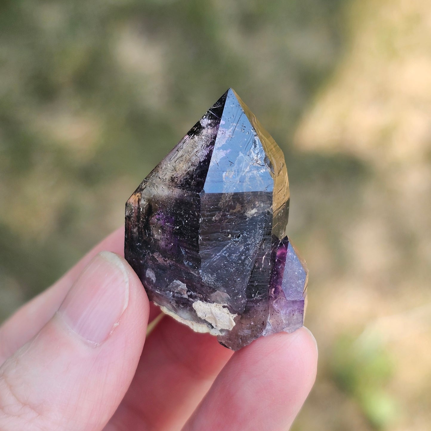 Handheld A-grade Brandberg phantom amethyst crystal with deep purple violet flame phantoms.