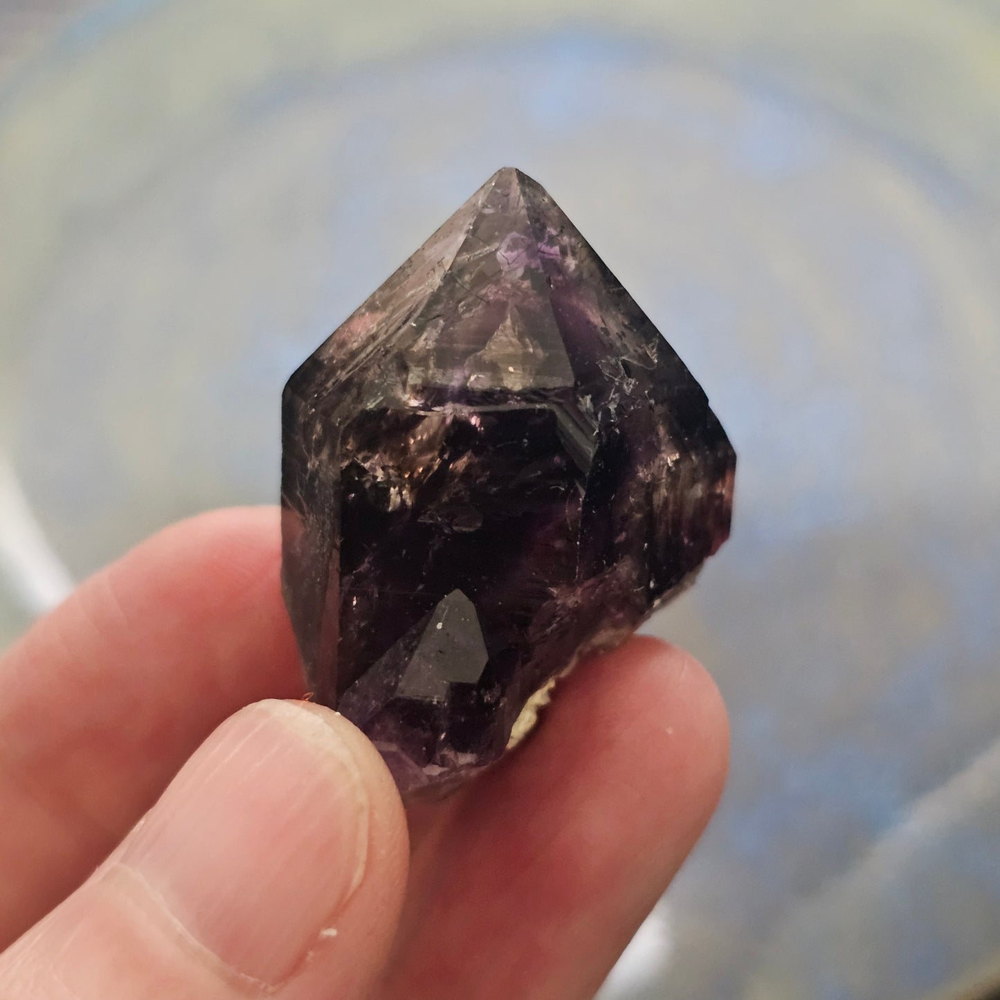 Handheld A-grade Brandberg phantom amethyst crystal with deep purple violet flame phantoms.