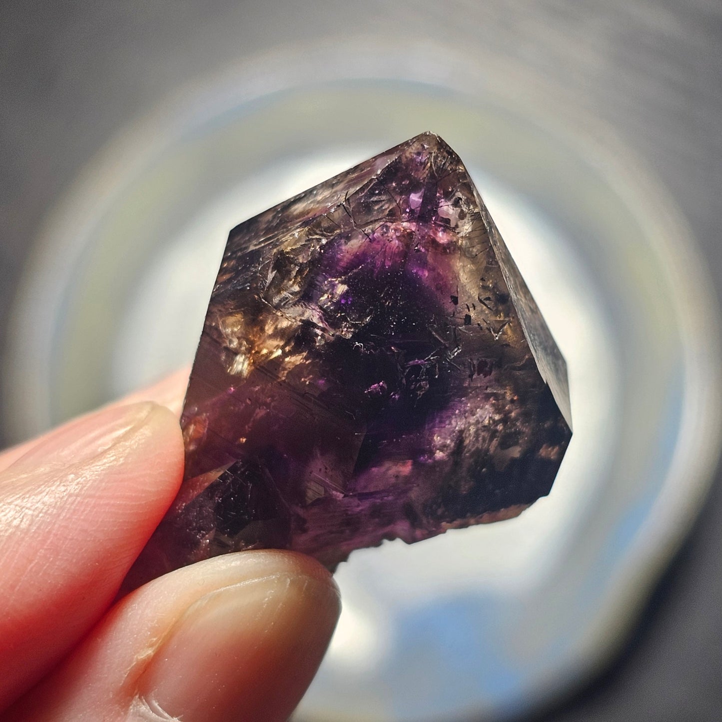 Handheld A-grade Brandberg phantom amethyst crystal with deep purple violet flame phantoms.