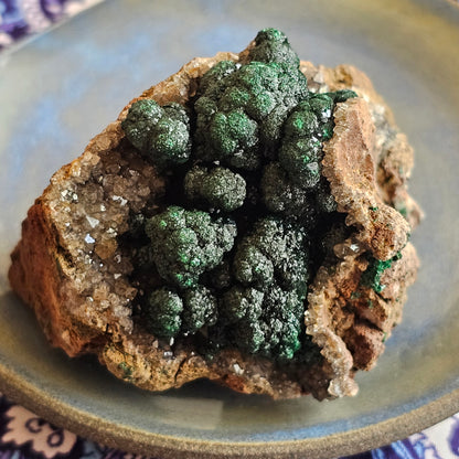 A-grade forest green Malachite balls clustered on a natural quartz-feldspar matrix from Mindigi Mine, Congo.