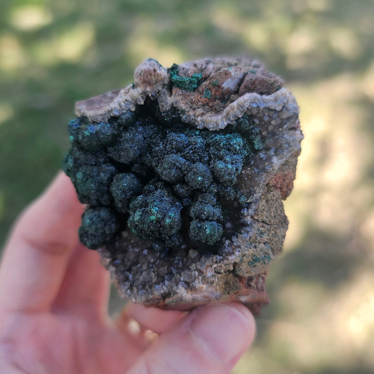 A-grade forest green Malachite balls clustered on a natural quartz-feldspar matrix from Mindigi Mine, Congo.