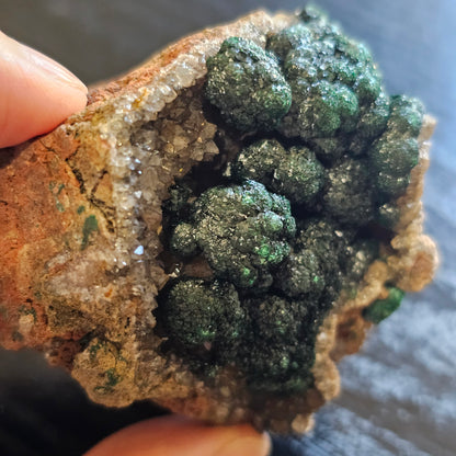 A-grade forest green Malachite balls clustered on a natural quartz-feldspar matrix from Mindigi Mine, Congo.