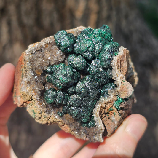 A-grade forest green Malachite balls clustered on a natural quartz-feldspar matrix from Mindigi Mine, Congo.