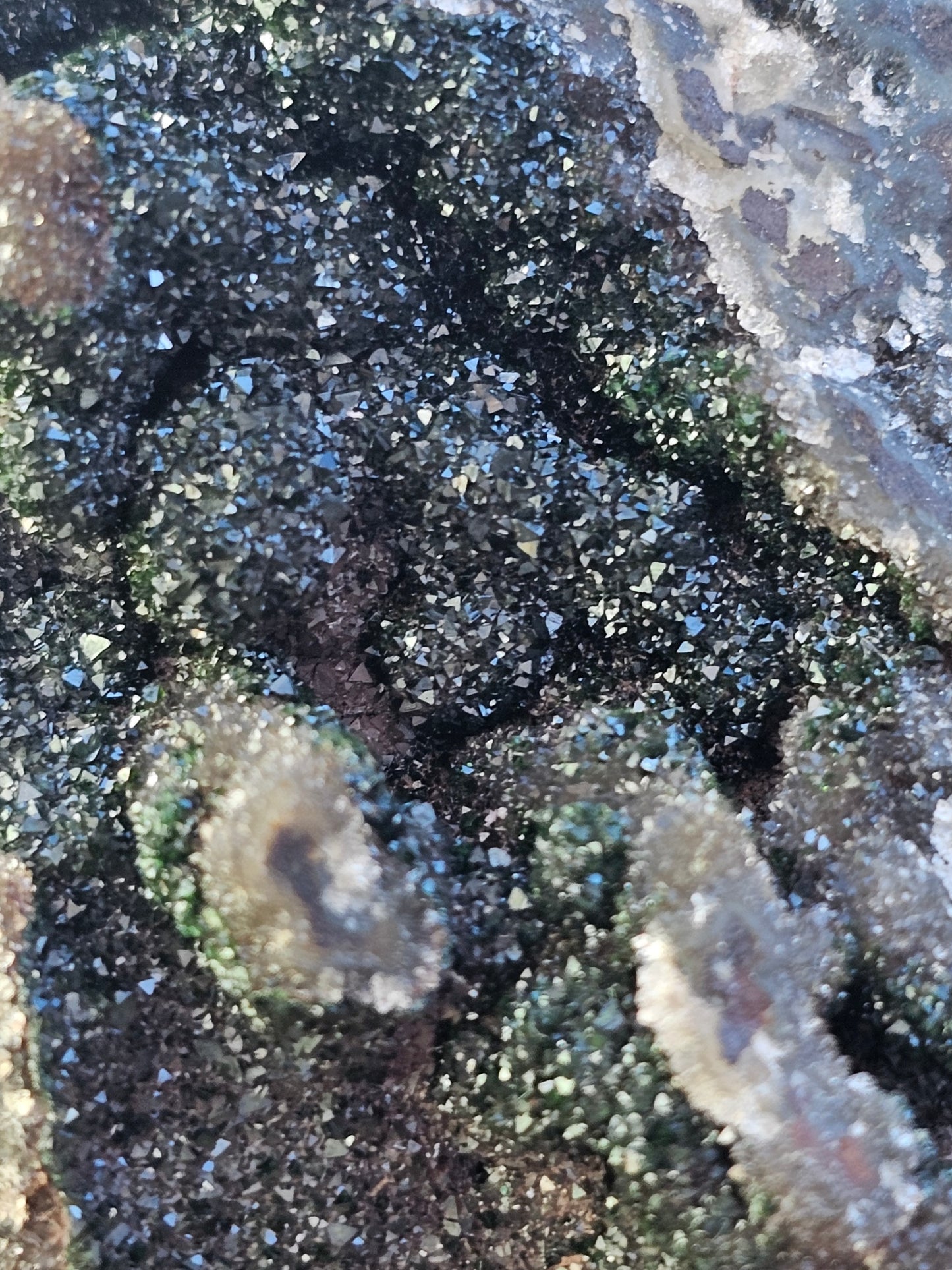 Macro close-up of sparkling white Druzy Quartz crystals over earthy green Duftite textures and grey Dolomite, highlighting the complex natural structure of the stone.