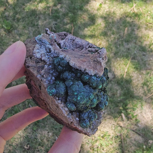 A-grade forest green Malachite balls clustered on a natural quartz-feldspar matrix from Mindigi Mine, Congo.
