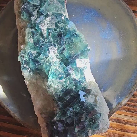 Video showing a Large Madagascar Fluorite shifting from natural blue-green light to mystical purple under UV light, highlighting its sharp cubic geometry.