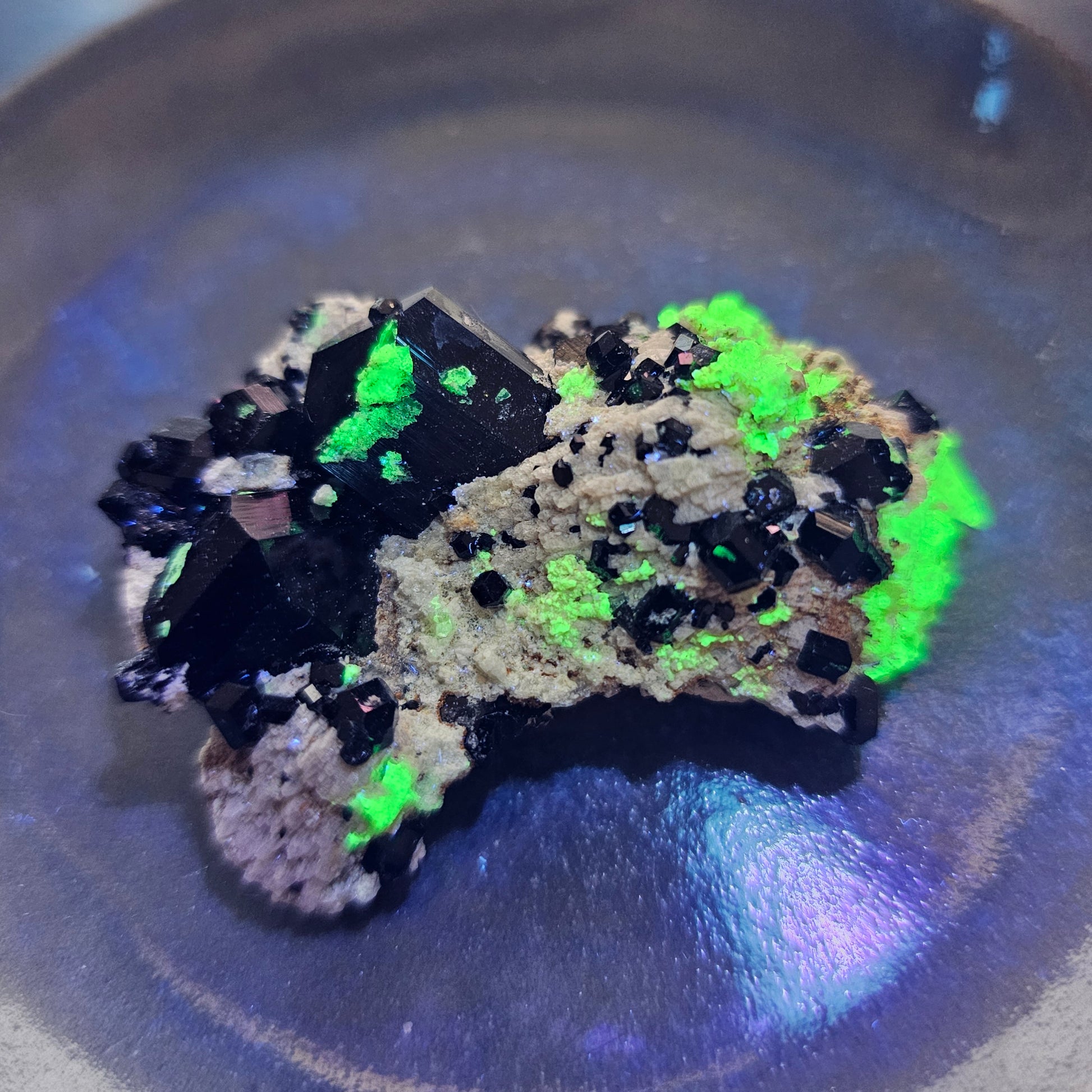 Close-up video of a 31.8g Black Schorl Tourmaline specimen from Erongo, Namibia, demonstrating the vibrant neon green glow of UV-reactive Hyalite Opal under ultraviolet light for empath energy protection.
