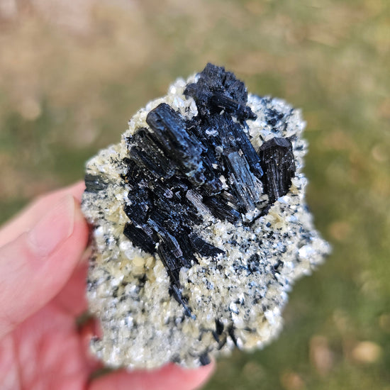 A 360-degree video showcase of the 75g Black Schorl Tourmaline and Hyalite Opal, emphasizing the light reflecting off the natural crystal facets and the sturdy, grounded presence of the Erongo specimen.