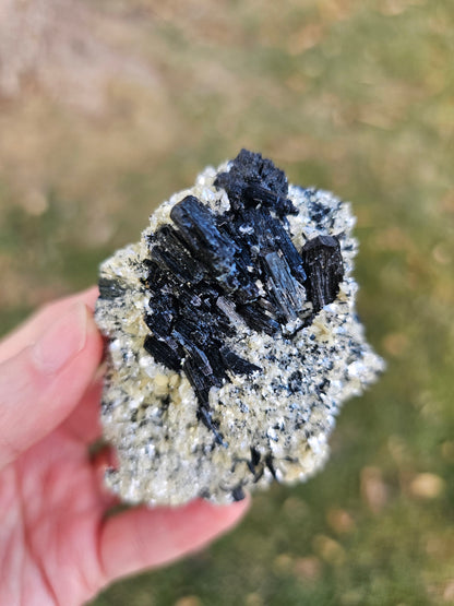 A 360-degree video showcase of the 75g Black Schorl Tourmaline and Hyalite Opal, emphasizing the light reflecting off the natural crystal facets and the sturdy, grounded presence of the Erongo specimen.