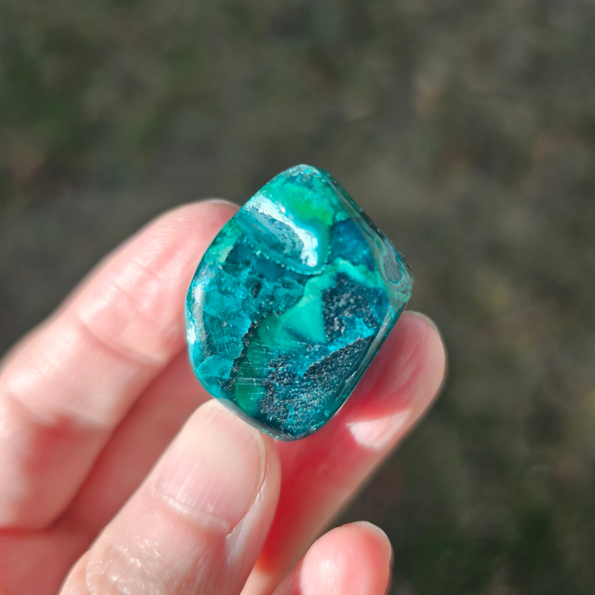 A high-definition video showcase of a 26.7g Congo freeform, slowly rotating to reveal the intricate layers of emerald Dioptase, deep indigo Shattuckite, forest green Malachite, and turquoise Chrysocolla. The video highlights the stone's polished texture, natural mineral transitions, and vibrant colors in natural light, demonstrating its size as a perfect palm stone for emotional healing.